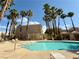 Community pool with palm trees and blue sky at 6873 Tamarus St # 201, Las Vegas, NV 89119