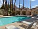Resort-style community pool with lounge chairs and shade at 6873 Tamarus St # 201, Las Vegas, NV 89119
