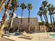 Inviting community pool area surrounded by lush palm trees and comfortable lounge chairs at 6873 Tamarus St # 201, Las Vegas, NV 89119