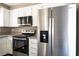 Updated kitchen boasts stainless steel appliances and granite countertops at 6873 Tamarus St # 201, Las Vegas, NV 89119