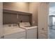 Laundry room with white washer and dryer, shelving, and a closet at 6873 Tamarus St # 201, Las Vegas, NV 89119