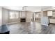Spacious living area features a fireplace, wood-look flooring, and views of the dining area at 6873 Tamarus St # 201, Las Vegas, NV 89119