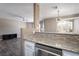 Open floor plan with kitchen bar, dining area and living room featuring newer floors at 6873 Tamarus St # 201, Las Vegas, NV 89119