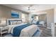 This main bedroom features a large bed, ceiling fan, and mirrored closet doors at 6873 Tamarus St # 201, Las Vegas, NV 89119