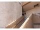 Exterior staircase leading to upper level apartments with textured walls and metal railings at 6873 Tamarus St # 201, Las Vegas, NV 89119