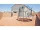 Large backyard featuring low-maintenance landscaping and a trampoline at 7002 Fossil Rim St, North Las Vegas, NV 89084
