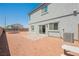 Spacious backyard with low-maintenance landscaping and access to the house at 7002 Fossil Rim St, North Las Vegas, NV 89084