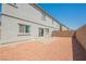 Nice backyard with low-maintenance rock landscaping and access to the house at 7002 Fossil Rim St, North Las Vegas, NV 89084