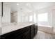 Bright bathroom features dual sinks, a soaking tub, and a separate glass-enclosed shower at 7002 Fossil Rim St, North Las Vegas, NV 89084