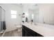 Bright bathroom featuring a large mirror, modern vanity, and a glass-enclosed shower at 7002 Fossil Rim St, North Las Vegas, NV 89084