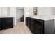 Bathroom with double sinks and wood-look floors, perfect for a modern home at 7002 Fossil Rim St, North Las Vegas, NV 89084