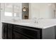 Bathroom featuring double sinks with a white countertop and wood look flooring at 7002 Fossil Rim St, North Las Vegas, NV 89084