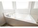 Close up of a new white bathtub with a tile surround and chrome fixtures at 7002 Fossil Rim St, North Las Vegas, NV 89084