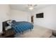 Cozy bedroom featuring a ceiling fan and a mounted television for relaxed evenings at 7002 Fossil Rim St, North Las Vegas, NV 89084
