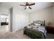 Cozy bedroom with soft carpet and closet, featuring a ceiling fan for comfortable temperatures at 7002 Fossil Rim St, North Las Vegas, NV 89084
