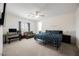 Bedroom with ceiling fan, bed, desk and seating at 7002 Fossil Rim St, North Las Vegas, NV 89084