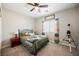 Comfortable bedroom featuring a ceiling fan, soft carpet, and a window with decorative curtains at 7002 Fossil Rim St, North Las Vegas, NV 89084