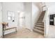 Welcoming entryway with staircase, bench, and modern design accents at 7002 Fossil Rim St, North Las Vegas, NV 89084
