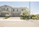 Inviting townhome with a two-car garage, lush landscaping, and a well-maintained exterior at 7002 Fossil Rim St, North Las Vegas, NV 89084