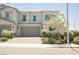 Charming townhome with a two-car garage, landscaped front yard, and a welcoming facade at 7002 Fossil Rim St, North Las Vegas, NV 89084