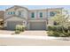 Charming two-story townhome featuring a neutral color palette and manicured landscaping at 7002 Fossil Rim St, North Las Vegas, NV 89084