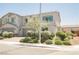 Beautiful two-story home with a two-car garage and green landscaping at 7002 Fossil Rim St, North Las Vegas, NV 89084