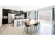 Modern kitchen with black cabinetry, stainless steel appliances, and an island with seating at 7002 Fossil Rim St, North Las Vegas, NV 89084