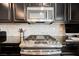 Close-up of kitchen featuring stainless steel gas range and microwave, plus herringbone backsplash at 7002 Fossil Rim St, North Las Vegas, NV 89084