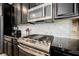 Stylish kitchen featuring black cabinets, stainless steel appliances, and sleek black countertops at 7002 Fossil Rim St, North Las Vegas, NV 89084