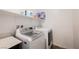 Bright laundry room featuring a modern, front-loading washer and dryer set at 7002 Fossil Rim St, North Las Vegas, NV 89084