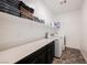 Bright laundry room with modern appliances, folding counter, and ample storage space at 7002 Fossil Rim St, North Las Vegas, NV 89084
