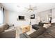 Cozy living room featuring a ceiling fan, comfortable seating, and ample natural light at 7002 Fossil Rim St, North Las Vegas, NV 89084