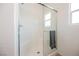 Clean white tile shower with glass enclosure and built-in seat, perfect for relaxation at 7002 Fossil Rim St, North Las Vegas, NV 89084