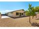 Low-maintenance backyard with gravel and trees on a sunny day at 7265 Southern Magnolia St, Las Vegas, NV 89149