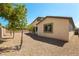 Backyard featuring gravel landscaping with trees on a sunny day at 7265 Southern Magnolia St, Las Vegas, NV 89149
