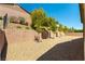 Minimalist backyard with a brick wall and gravel landscaping at 7265 Southern Magnolia St, Las Vegas, NV 89149