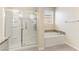 Bathroom featuring a separate glass shower and tub with decorative stone detail at 7265 Southern Magnolia St, Las Vegas, NV 89149