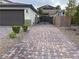A large, paved driveway leading to a wrought iron gate offers privacy and RV parking at 7265 Southern Magnolia St, Las Vegas, NV 89149
