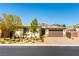 Charming single-story home with a two-car garage, complemented by a well-maintained front yard and desert landscaping at 7265 Southern Magnolia St, Las Vegas, NV 89149