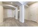 Bright foyer with neutral walls, gray tile floors, arched entryways, and a white front door at 7265 Southern Magnolia St, Las Vegas, NV 89149