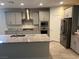 Modern kitchen featuring gray cabinets, stainless steel appliances, and granite countertops at 7265 Southern Magnolia St, Las Vegas, NV 89149
