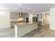 Modern kitchen with gray cabinets, granite countertops, stainless steel appliances, and tile floors at 7265 Southern Magnolia St, Las Vegas, NV 89149
