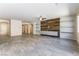 Spacious living room with modern tile flooring, a ceiling fan, accent wall, and shelving at 7265 Southern Magnolia St, Las Vegas, NV 89149