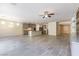 Open-concept living room with tile floors, gray kitchen cabinets, and decorative lighting at 7265 Southern Magnolia St, Las Vegas, NV 89149