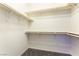 Spacious walk-in closet with multiple shelves and hanging rods for ample storage at 7265 Southern Magnolia St, Las Vegas, NV 89149