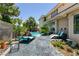 Relaxing backyard with sparkling pool, lounge chairs, desert landscaping, and a charming covered patio at 7718 Willow Cove Cir, Las Vegas, NV 89129