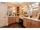 Spacious bathroom featuring a double vanity, dark wood floors, and makeup counter at 7718 Willow Cove Cir, Las Vegas, NV 89129