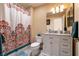 Nicely appointed bathroom with white cabinets, white marble countertop, and decorative shower curtain at 7718 Willow Cove Cir, Las Vegas, NV 89129