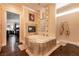 Bathroom featuring a large soaking tub with fireplace, vanity, neutral walls, and dark wood floor at 7718 Willow Cove Cir, Las Vegas, NV 89129