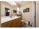 Bright bathroom featuring tiled floors and a vanity with a sink, mirror, and decorative lighting at 7718 Willow Cove Cir, Las Vegas, NV 89129